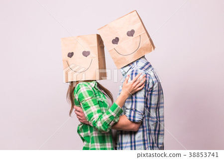 Love couple covering their faces with paper bag 38853741