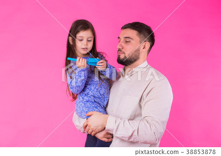 Happy father holding baby daughter in hands over Happy father holding baby daughter in hands over 38853878