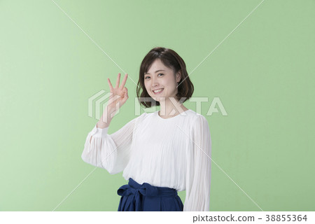 Young Woman OK Sign Green Back 38855364