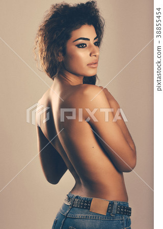 Young woman with beautiful back wearing blue jeans Young woman with beautiful back wearing blue jeans 38855454