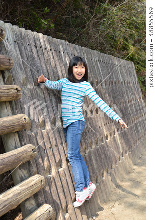 Girls playing with park play equipment 38855569