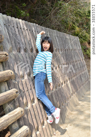 Girls playing with park play equipment 38855571