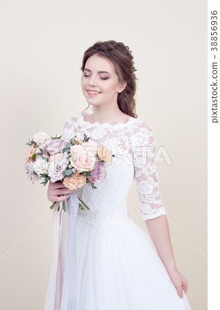 female model holding a bouquet of flowers 38856936