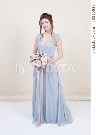 female model holding a bouquet of flowers 38856938