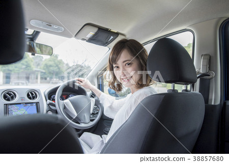 Young woman in the driver's seat of a car 38857680