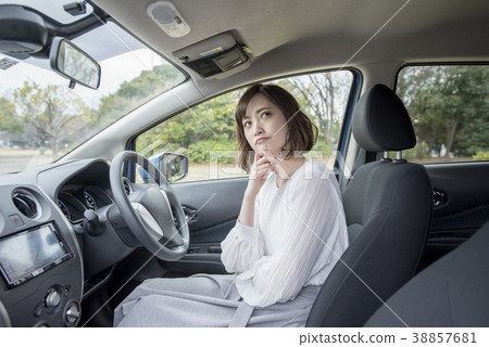 Young woman thinking in the driver's seat 38857681
