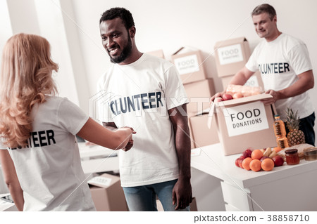 Attentive man packing charity parcel 38858710