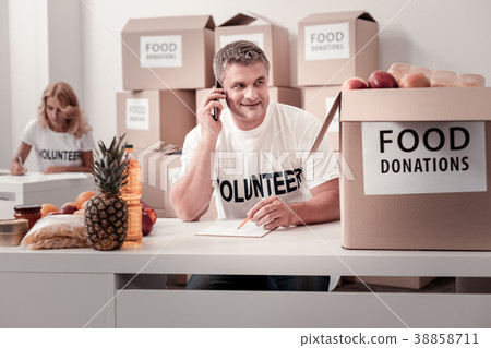 Enigmatical grey-haired man looking at box Enigmatical grey-haired man looking at box 38858711