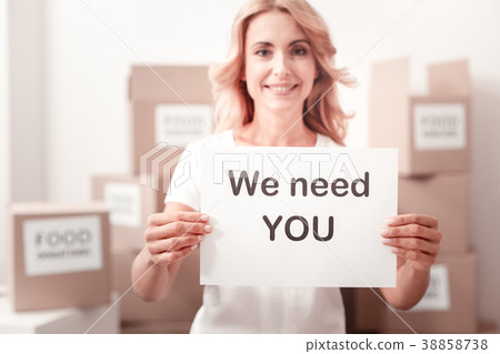 Attractive volunteer female holding announcement Attractive volunteer female holding announcement 38858738