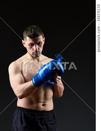 Low key studio portrait of handsome muscular Low key studio portrait of handsome muscular 38859158