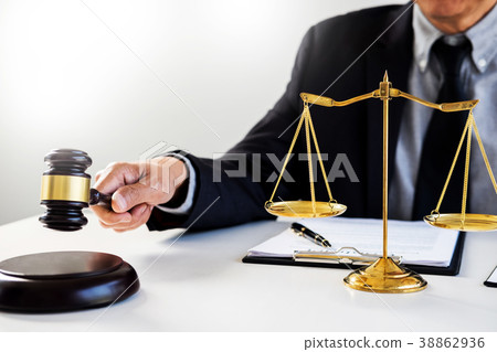 Male Judge lawyer In A Courtroom Striking The Gavel on sounding Male Judge lawyer In A Courtroom Striking The Gavel on sounding 38862936