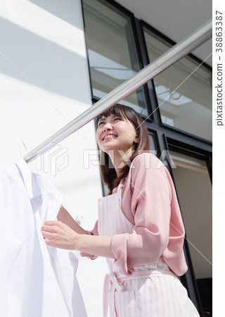 Housewife drying laundry Housewife drying laundry 38863387