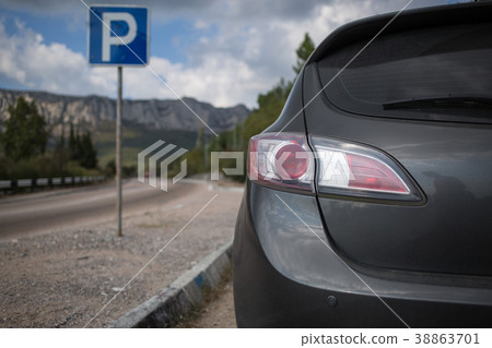 Car and blue parking sign 38863701