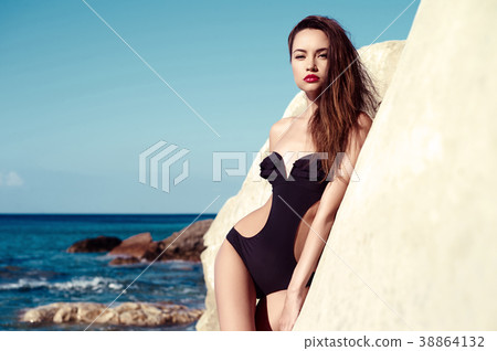 Beautiful slender brunette at the sea 38864132