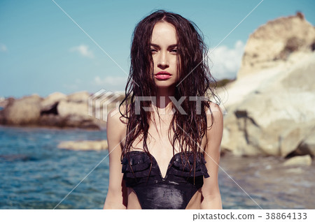 Beautiful slender brunette at the sea Beautiful slender brunette at the sea 38864133