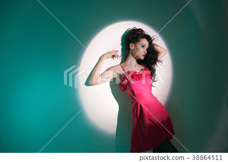 Beautiful brunette woman in beam of searchlight Beautiful brunette woman in beam of searchlight 38864511