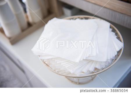 Stack of paper napkins on basket 38865034