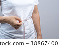 Woman measuring her belly 38867400