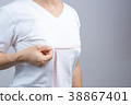Woman measuring her small breast size 38867401