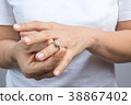 Woman put on her wedding ring 38867402