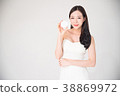 Asian woman holding cosmetics makeup product 38869972