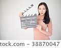 sian woman holding movie clapper board on white 38870047