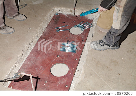 The builder rotates the nuts with an wrench The builder rotates the nuts with an wrench 38870263
