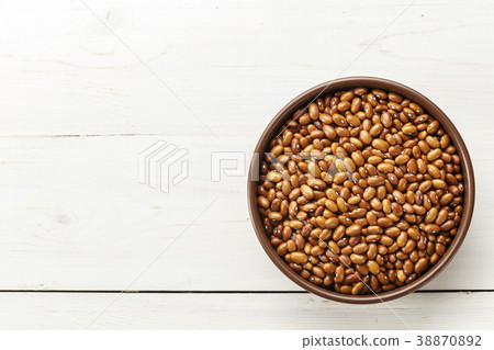 brown beans in a plate on a wooden background 38870892