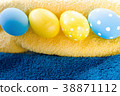 Blue and yellow Easter eggs on rustic background 38871112