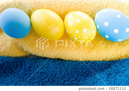Blue and yellow Easter eggs on rustic background Blue and yellow Easter eggs on rustic background 38871112