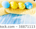 Blue and yellow Easter eggs on rustic background 38871113