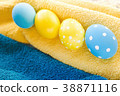 Blue and yellow Easter eggs on rustic background 38871116