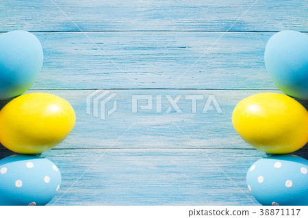 Blue and yellow Easter eggs on rustic background Blue and yellow Easter eggs on rustic background 38871117