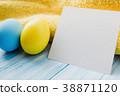 Blue and yellow Easter eggs on rustic background 38871120