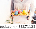 girl holding a basket with Easter eggs 38871123