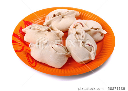 Frozen manti laying on the orange plate 38871186