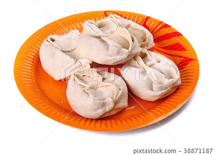 Frozen manti laying on the orange plate 38871187