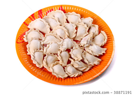 Frozen vareniki laying on the orange plate Frozen vareniki laying on the orange plate 38871191