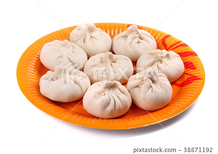Frozen manti laying on the orange plate Frozen manti laying on the orange plate 38871192