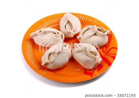 Frozen manti laying on the orange plate Frozen manti laying on the orange plate 38871193