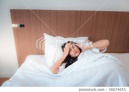 Pretty asian woman feeling headache after waked up Pretty asian woman feeling headache after waked up 38874055