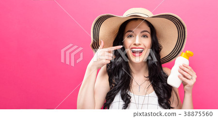 Young woman holding a bottle of sunblock 38875560