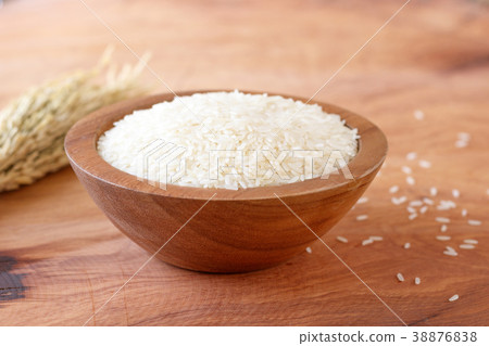 White rice in bowl on wooden background. White rice in bowl on wooden background. 38876838