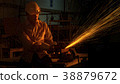 worker cuts metal cutting machine, focus on light 38879672