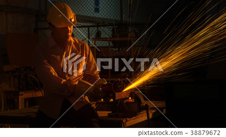 worker cuts metal cutting machine, focus on light 38879672