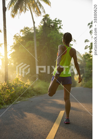 runner warming up before run on  forest trail 38880620