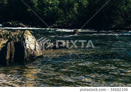 Fast mountain river in rapid flow Fast mountain river in rapid flow 38882106