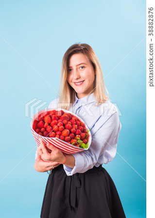 Young woman holding bouquet of strawberries on Young woman holding bouquet of strawberries on 38882876