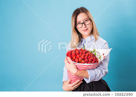 Young woman holding bouquet of strawberries on 38882890