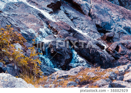 Mountain waterfall on a summer day Mountain waterfall on a summer day 38882929